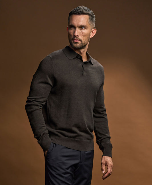 Model wearing the Tee Jays Men’s Knit Polo Shirt in Black, front view