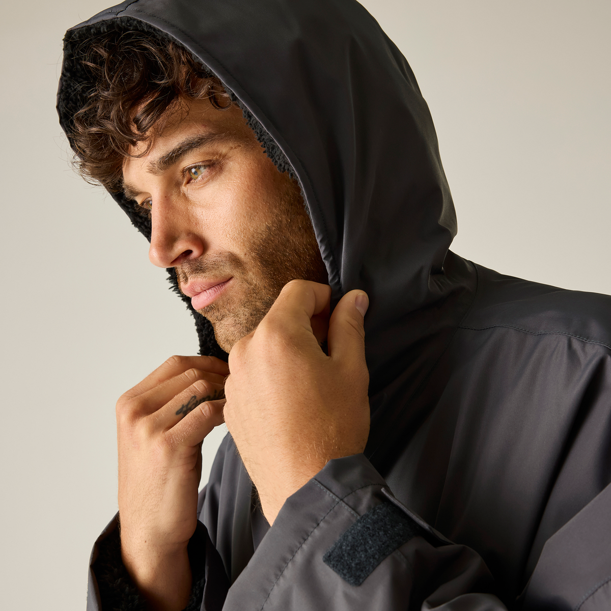 Model wearing the Regatta Pro Changing Dryrobe Jacket in Slate Grey and Black, close-up, hood up
