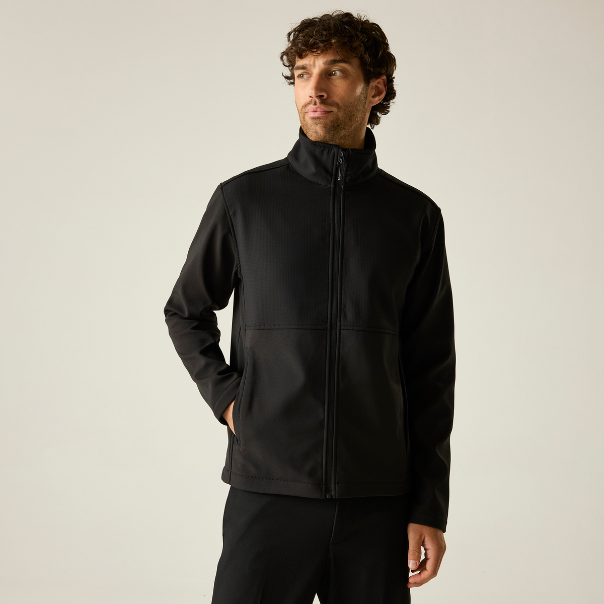 Model wearing the Regatta Recycle.Me Unisex Softshell Jacket in Black, front view