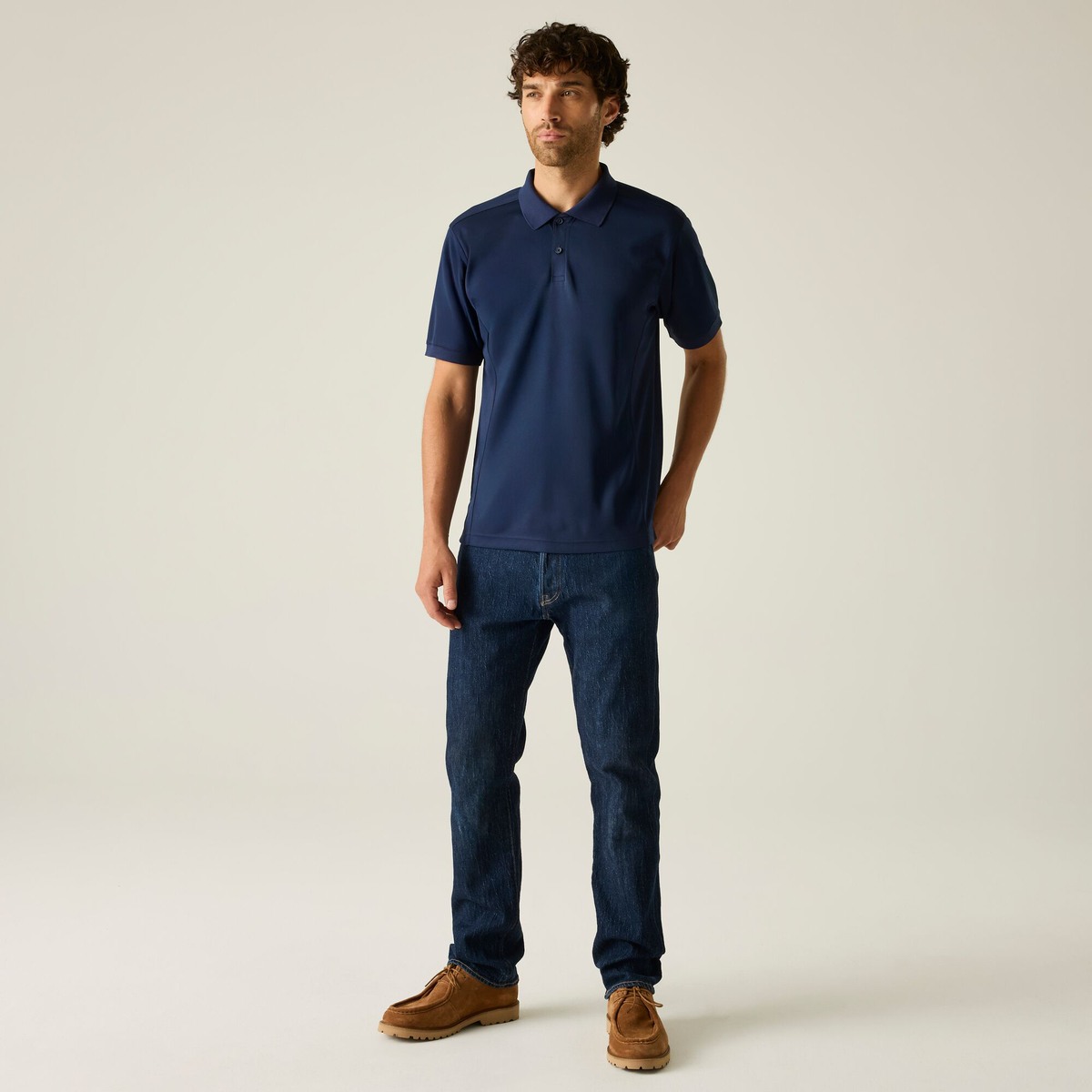 Model wearing the Regatta Recycle.Me Unisex Pique Polo Shirt in Navy, front view, full length