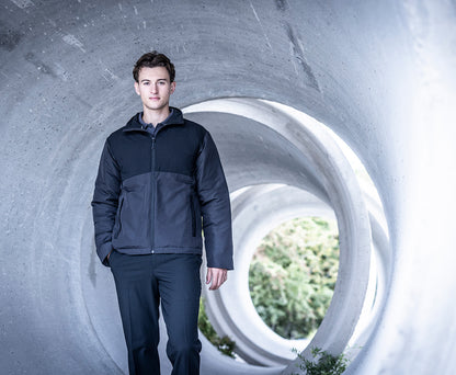 Man wearing the Regatta Recycle.Me Thermal Jacket in Black, standing in a concrete pipe