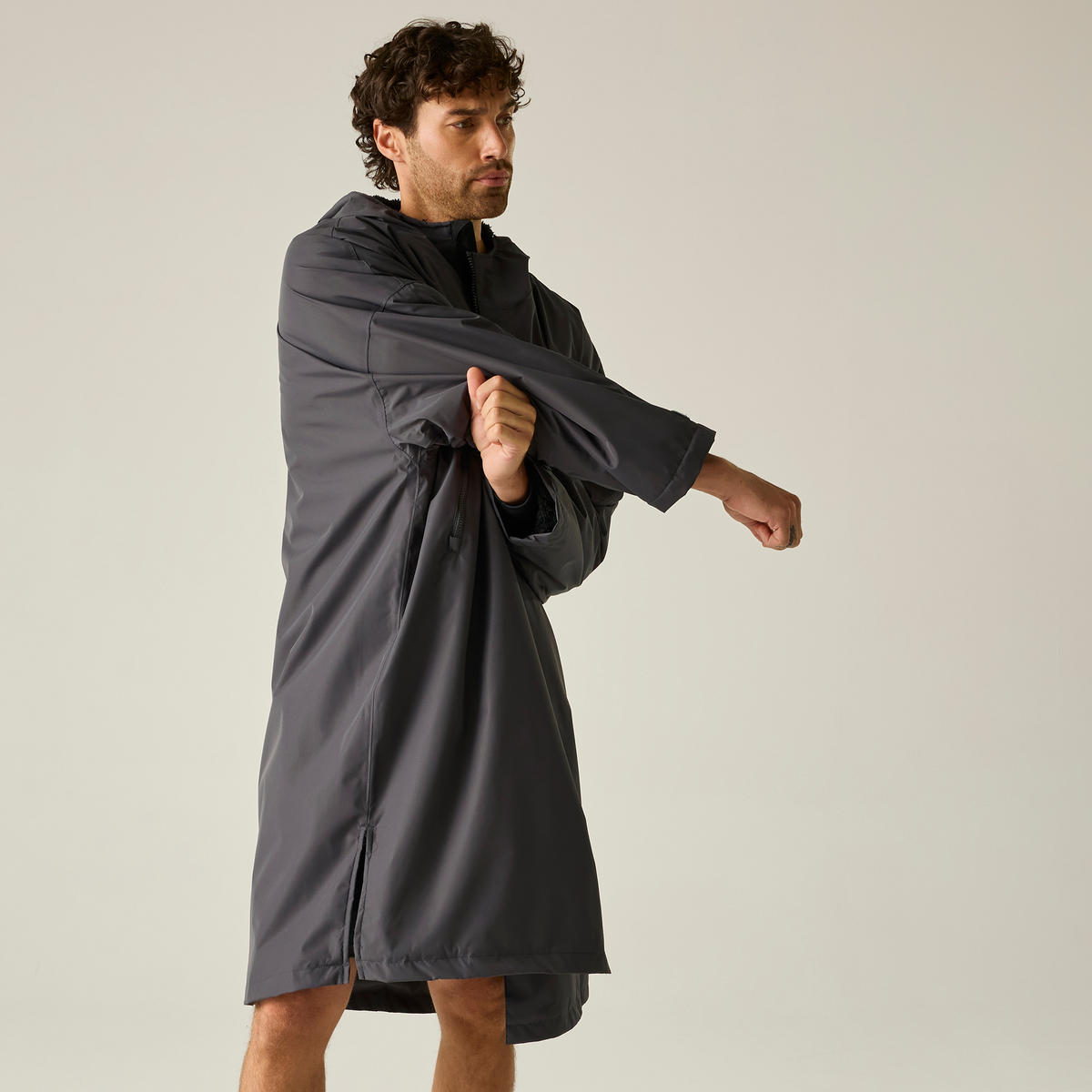 Model wearing the Regatta Pro Changing Dryrobe Jacket in Slate Grey and Black, front view, changing inside it