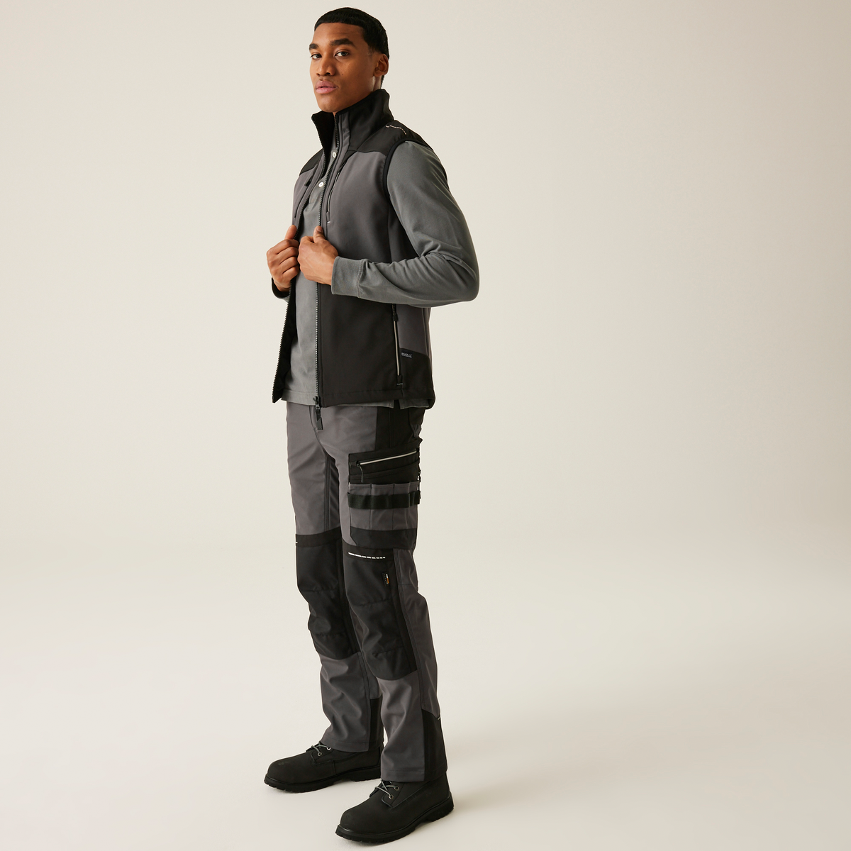Model wearing the Regatta 4TEX Men's Stretch 3-Layer Softshell Bodywarmer in Slate Grey and Black, front view, full length