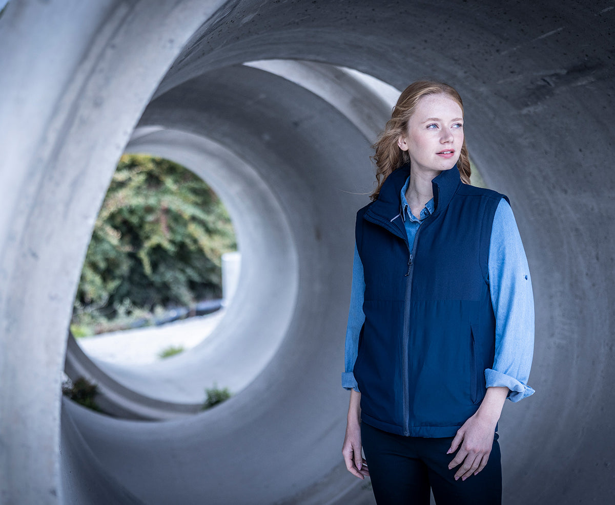 Woman wearing the Regatta Recycle.Me Thermal Bodywarmer in Navy, standing in a concrete pipe