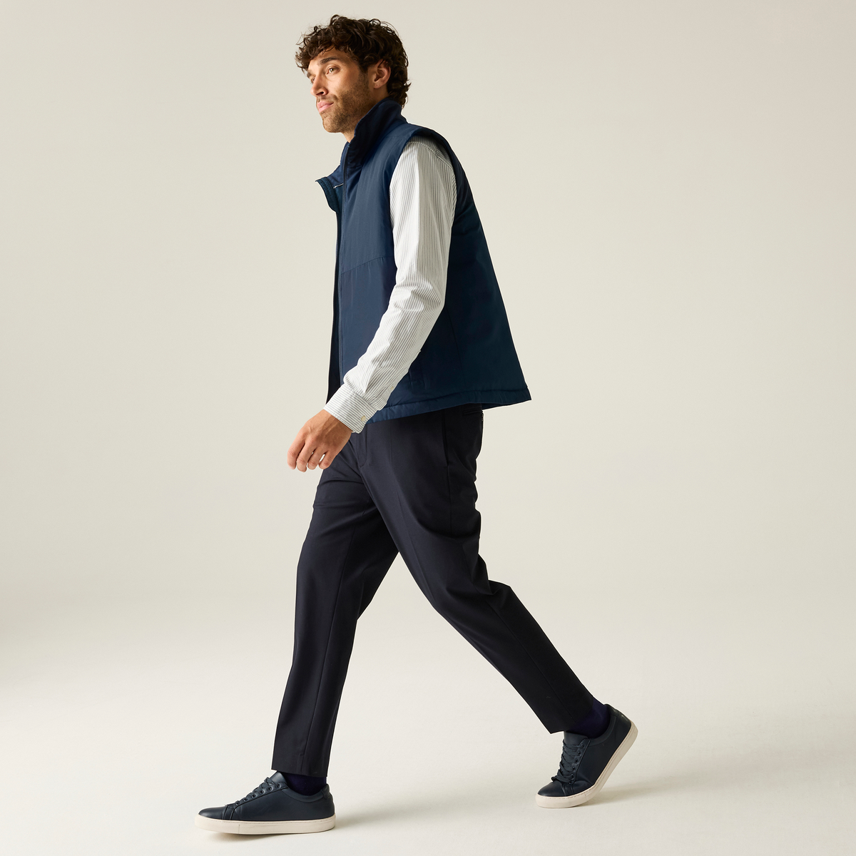 Model wearing the Regatta Recycle.Me Thermal Bodywarmer in Navy, side view, walking, full length