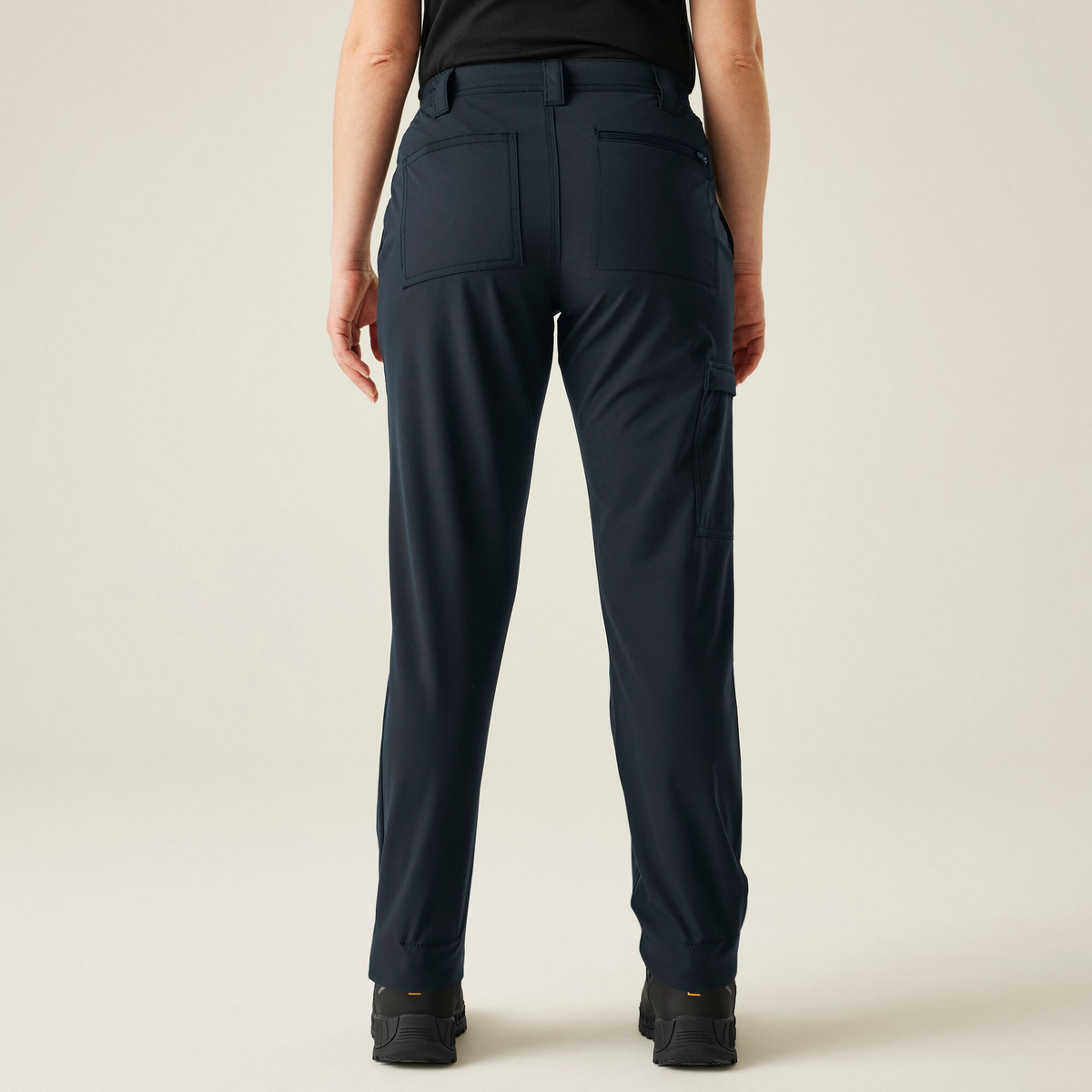 Model wearing the Regatta Pro Ladies Action Stretch Trousers in Navy, back view