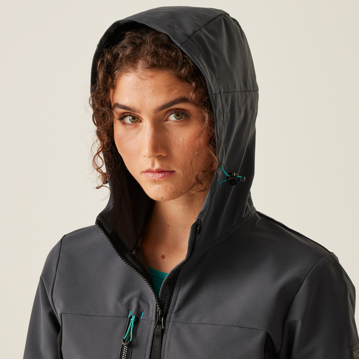 Model wearing the Regatta Ada Ladies Stretch Softshell Jacket in Seal Grey and Black, close-up, hood up