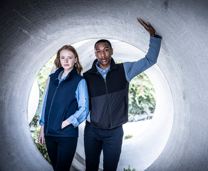 Woman and man wearing the Regatta Recycle.Me Thermal Bodywarmer, standing in a concrete pipe