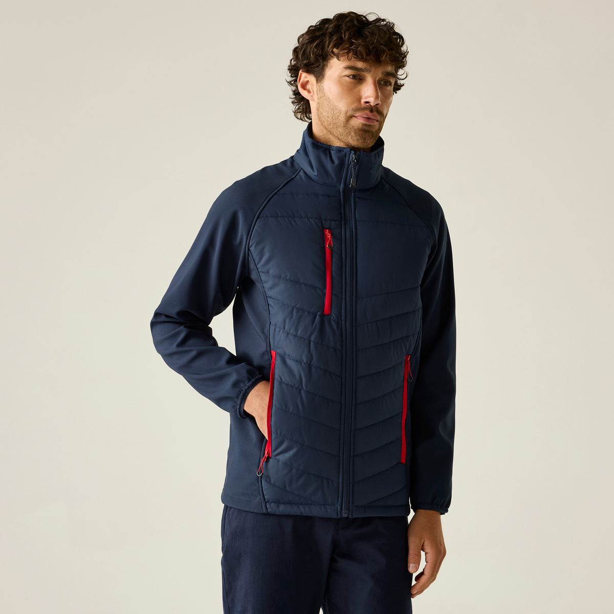 Model wearing the Regatta Pro Men’s Universal Jacket in Navy and Classic Red, front view