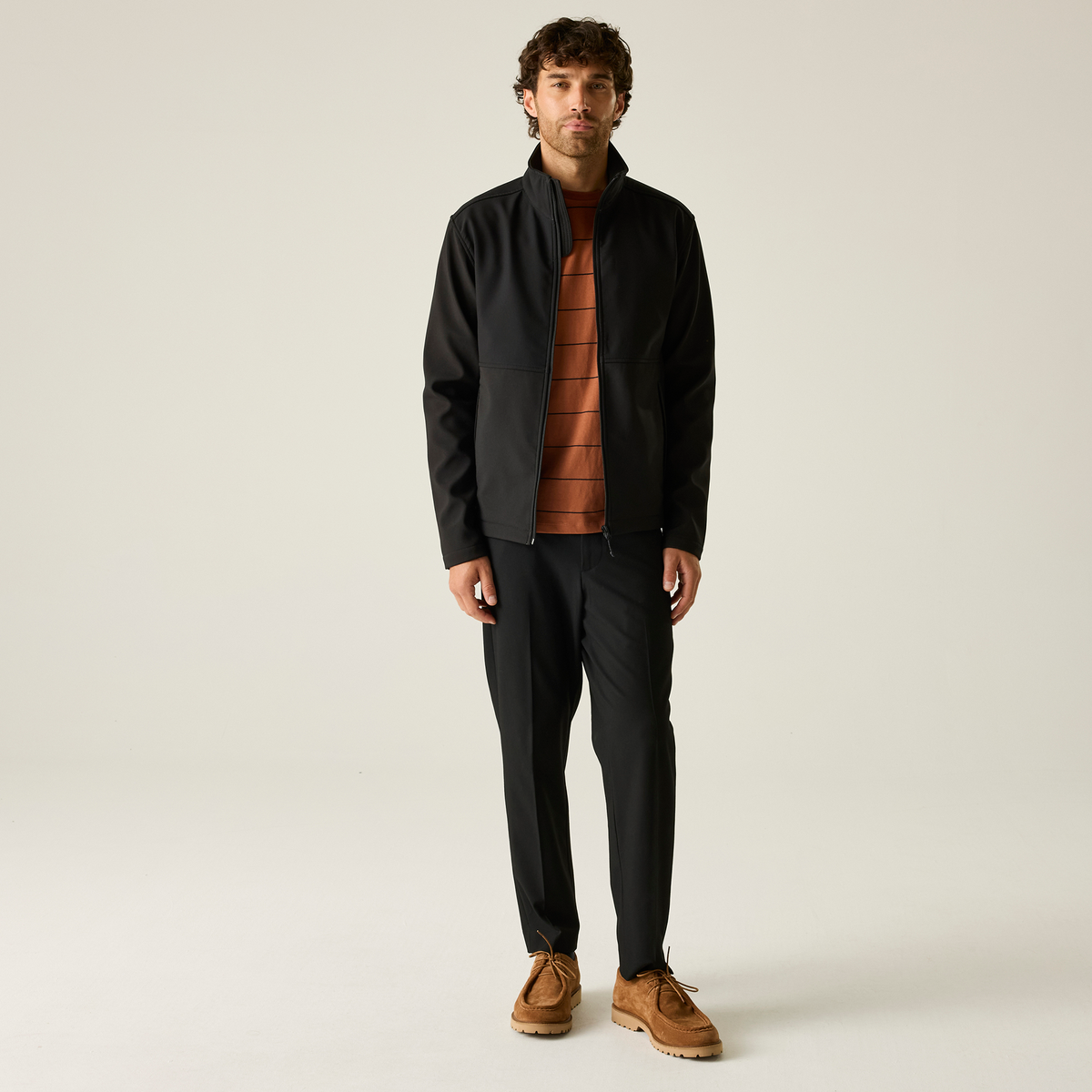 Model wearing the Regatta Recycle.Me Unisex Softshell Jacket in Black, front view, full length
