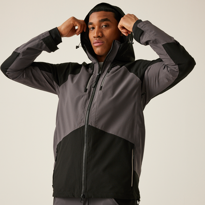 Model wearing the Regatta 4TEX Men's Stretch Waterproof Shell Jacket in Slate Grey and Black, front view, putting the hood up