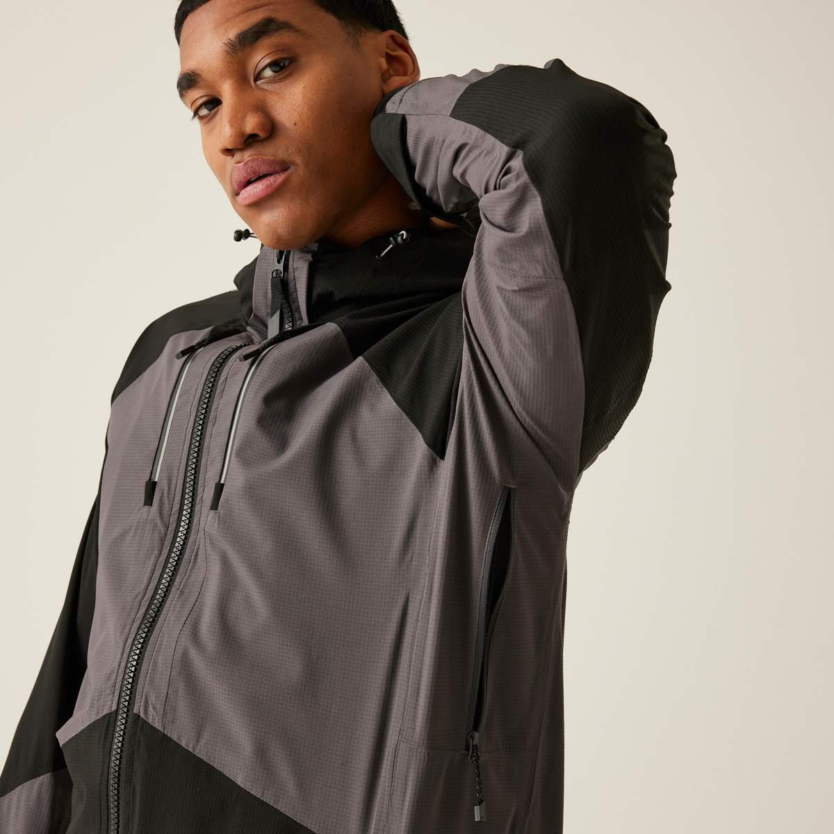 Model wearing the Regatta 4TEX Men's Stretch Waterproof Shell Jacket in Slate Grey and Black, close-up, arm raised