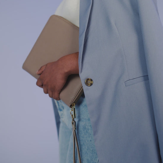 Video of a person carrying the BagBase Boutique Travel/Tech Organiser in Taupe under their arm