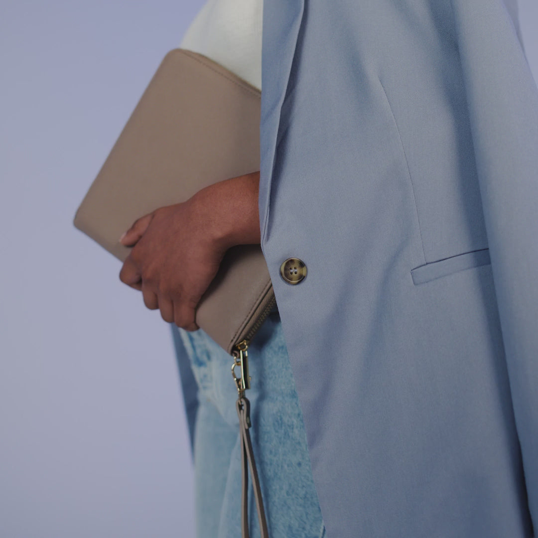 Video of a person carrying the BagBase Boutique Travel/Tech Organiser in Taupe under their arm