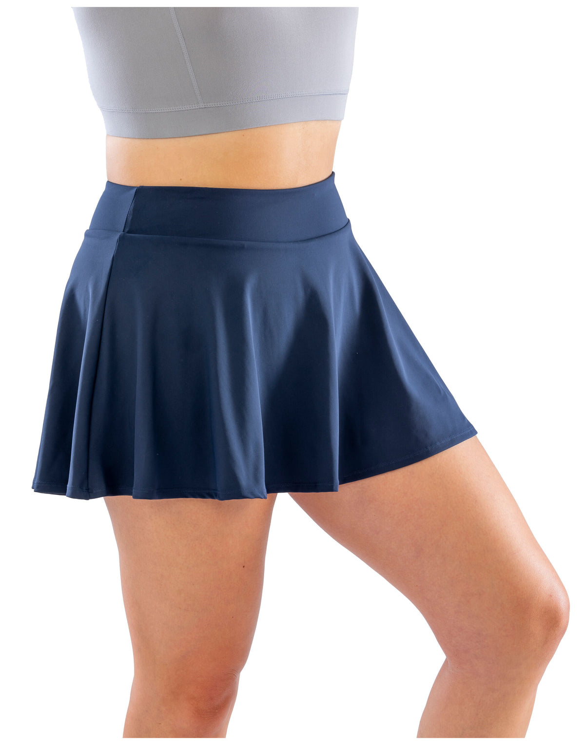 Model wearing the Spiro Recycled Ladies Fitness Skort in Navy, side view