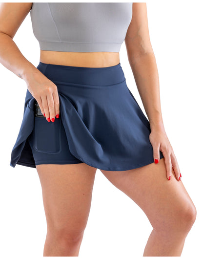 Model wearing the Spiro Recycled Ladies Fitness Skort in Navy, close-up, hand in the pocket