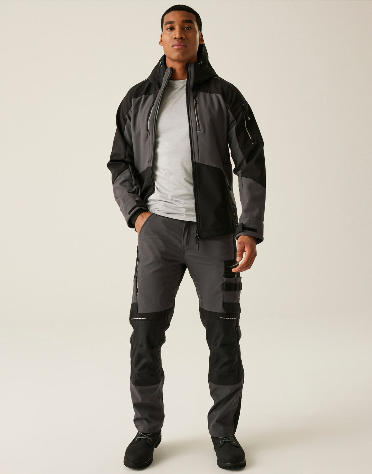 Model wearing the Regatta 4TEX Men's Stretch 3-Layer Softshell Jacket in Slate Grey and Black, front view, full length