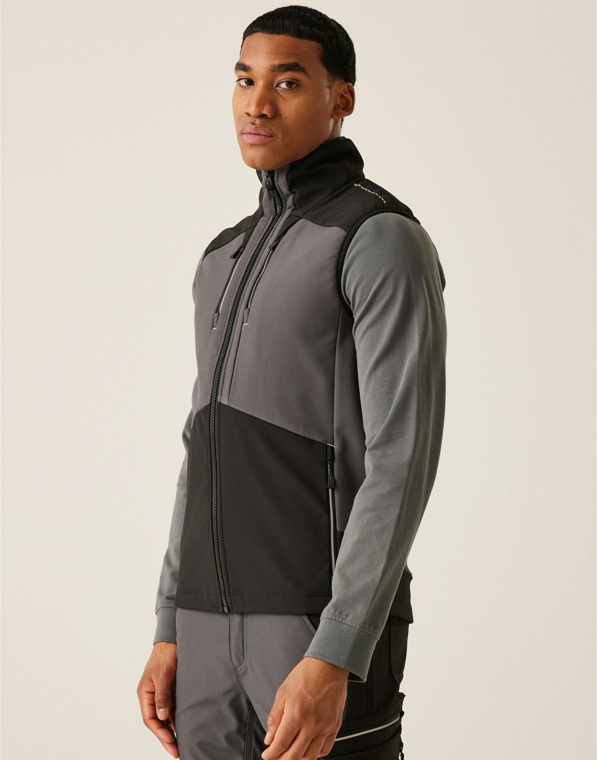 Model wearing the Regatta 4TEX Men's Stretch 3-Layer Softshell Bodywarmer in Slate Grey and Black, front view