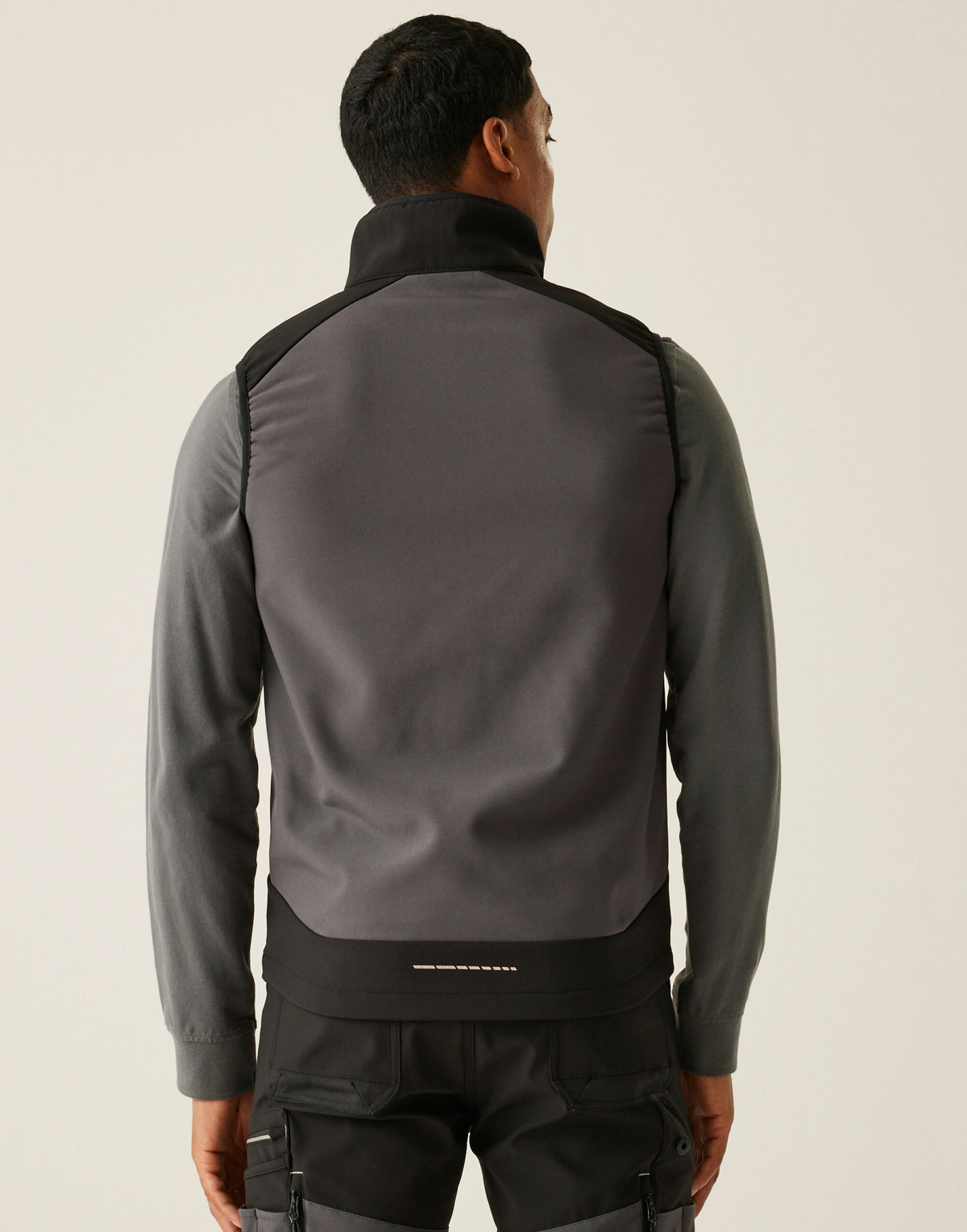 Model wearing the Regatta 4TEX Men's Stretch 3-Layer Softshell Bodywarmer in Slate Grey and Black, back view
