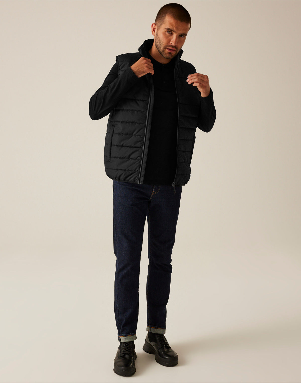 Model wearing the Regatta Essential Men's Thermal Bodywarmer in Black, front view, full length, adjusting the collar