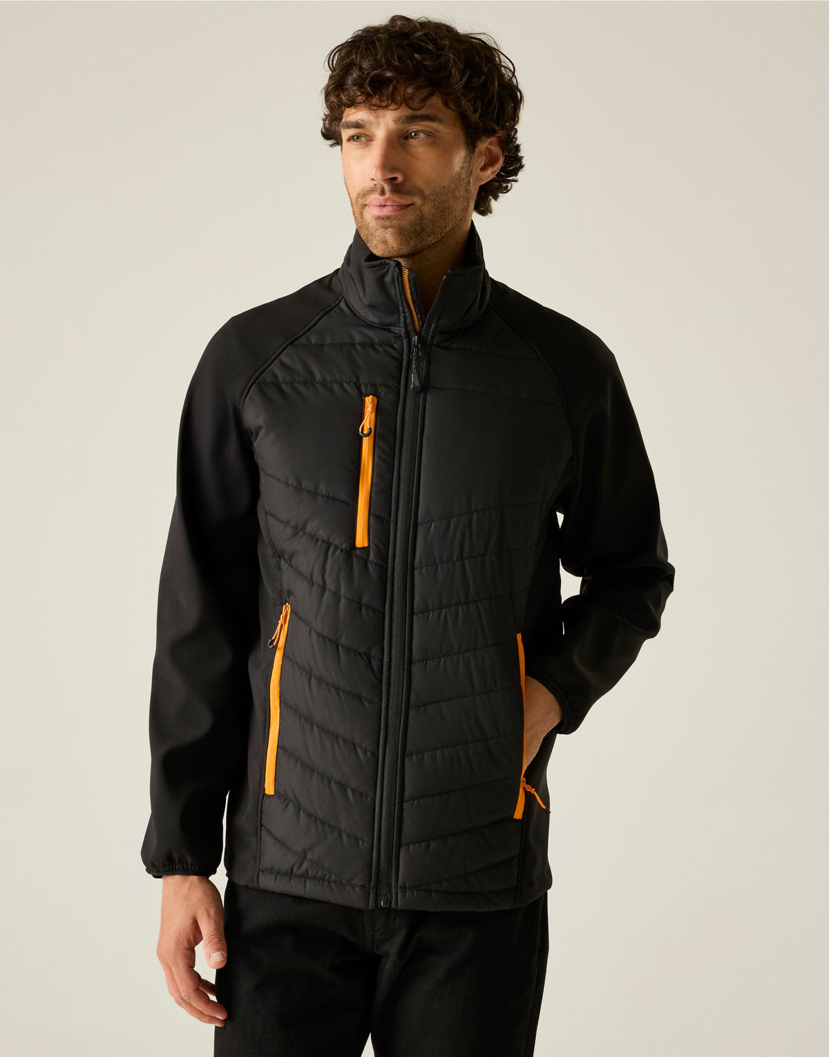 Model wearing the Regatta Pro Men’s Universal Jacket in Black Orange Pop, front view