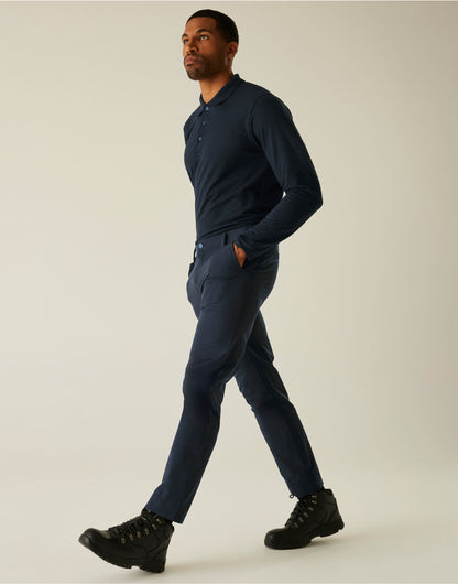Model wearing the Regatta Pro Men’s Action Stretch Trousers Regular Fit in Navy, side view, walking