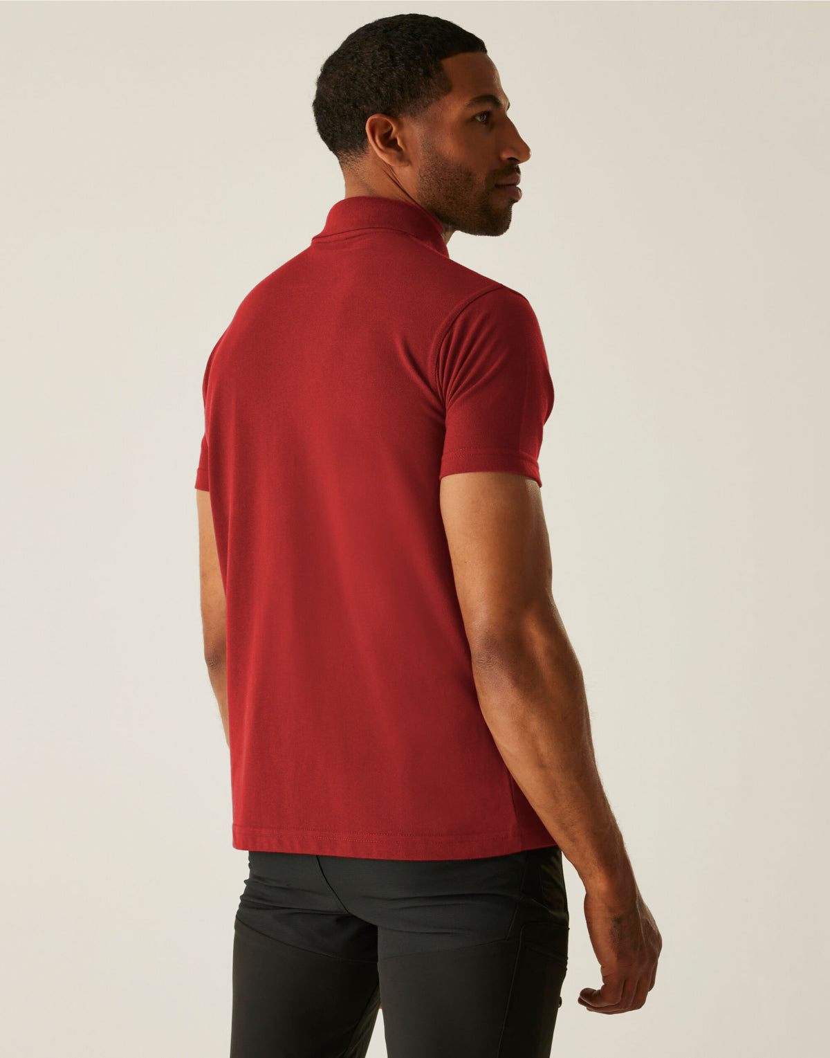 Model wearing the Regatta Pro Men’s 50/50 Pique Polo Shirt in Red, back view