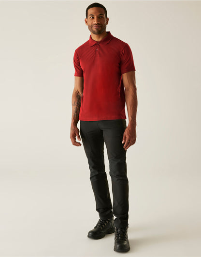 Model wearing the Regatta Pro Men’s 50/50 Pique Polo Shirt in Red, front view, full length