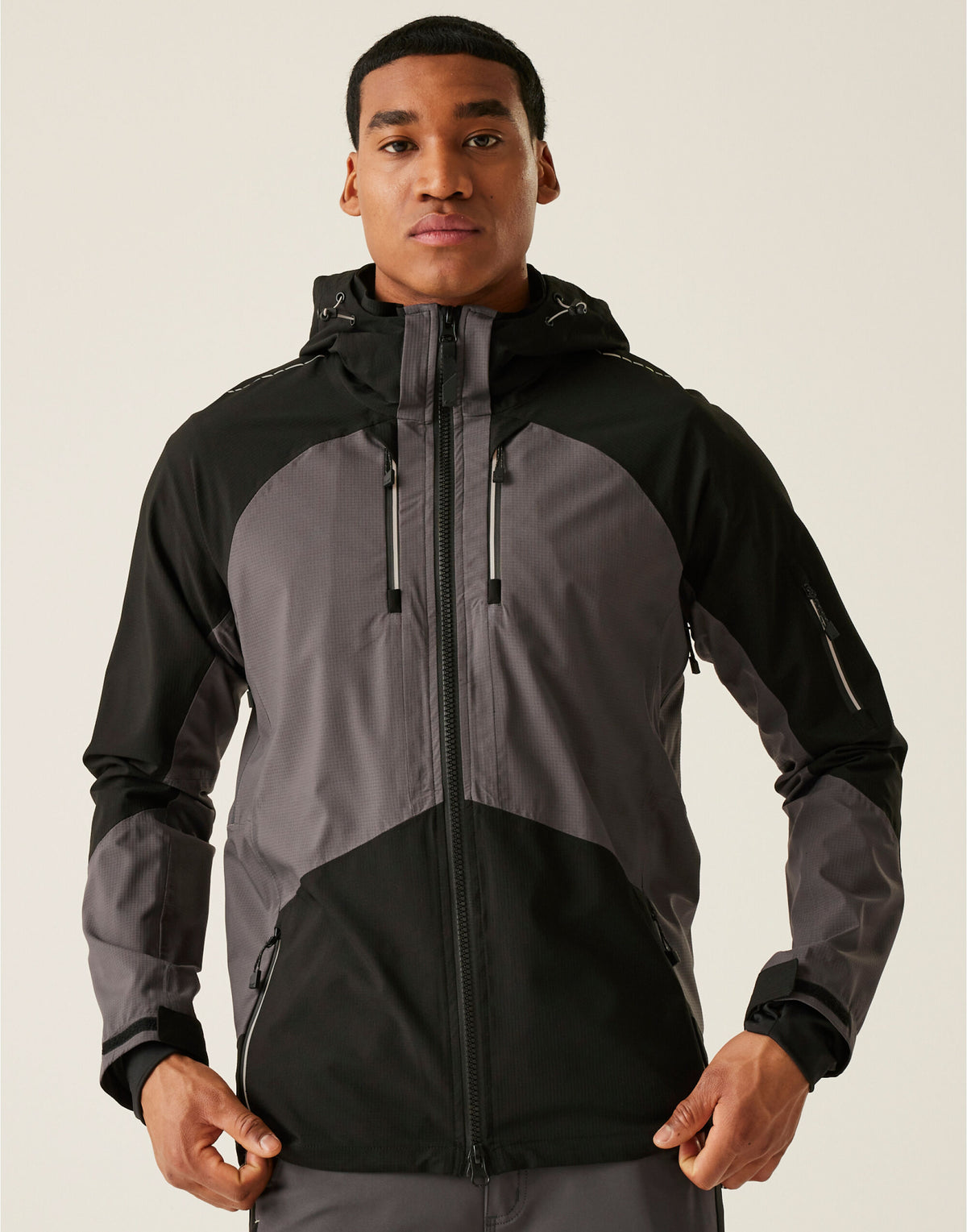 Model wearing the Regatta 4TEX Men's Stretch Waterproof Shell Jacket in Slate Grey and Black, front view