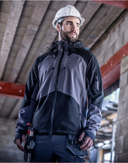 Man in a hard hat wearing the Regatta 4TEX Men's Stretch Waterproof Shell Jacket, looking to one side on a building site